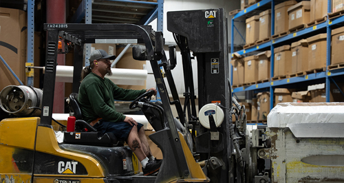 Fork-lift driver in warehouse