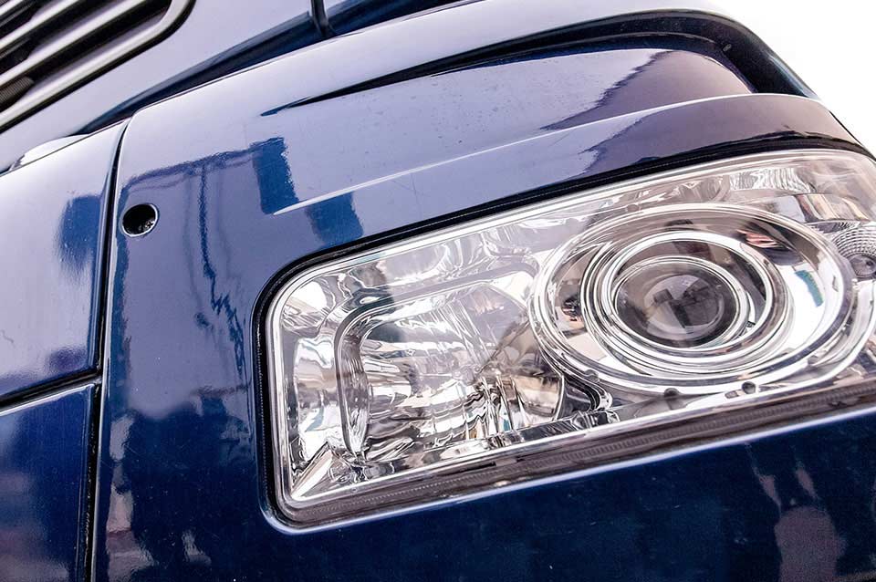Lamp close-up on a blue semi-truck, showing the application of automotive grade plastics